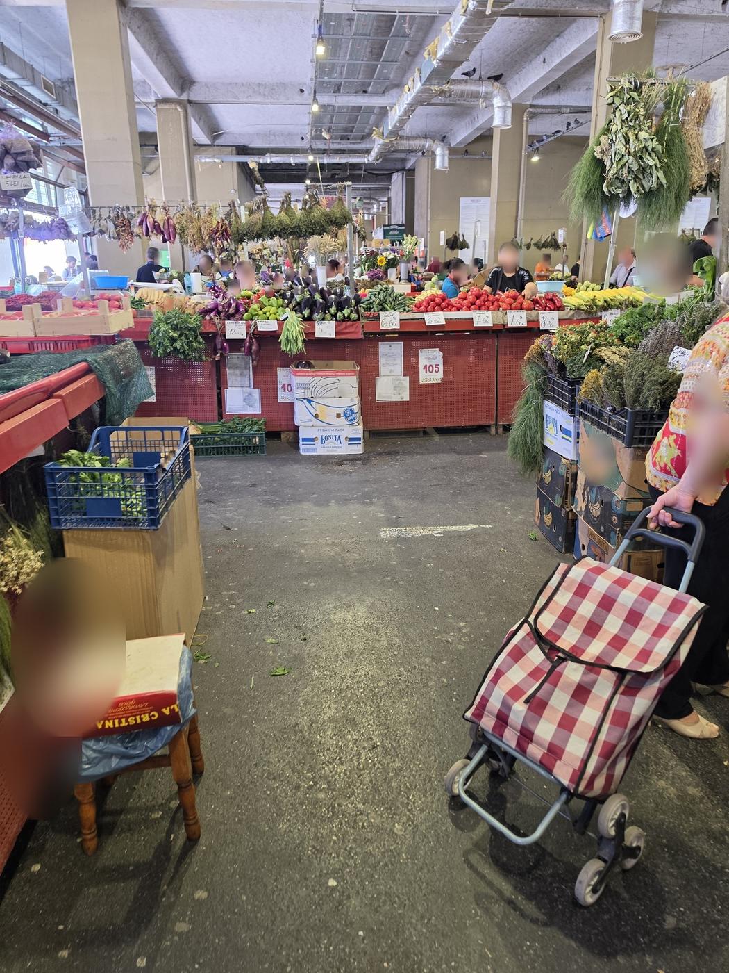 Inside Obor Market in Bucharest, with vegetable stalls, herbs and local shoppers